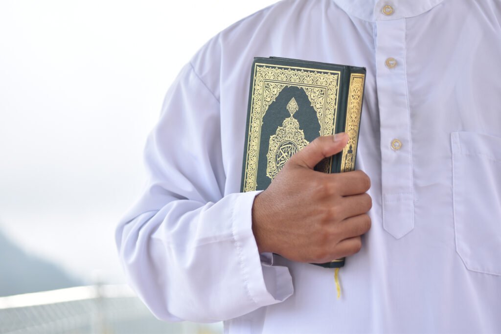 holy quran in hand with arabic calligraphy meaning 2026 01 08 00 21 44 utc